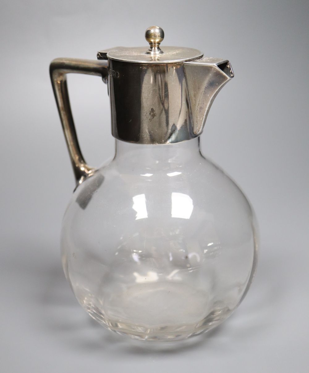 A late Victorian silver-mounted glass globular claret jug in the style of Christopher Dresser, Sheffield, 1897